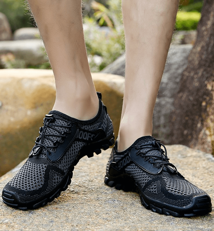 Breathable elastic camping shoes for men, featuring a mesh upper, rubber outsole, lace-up closure, and EVA insole, ideal for outdoor activities.